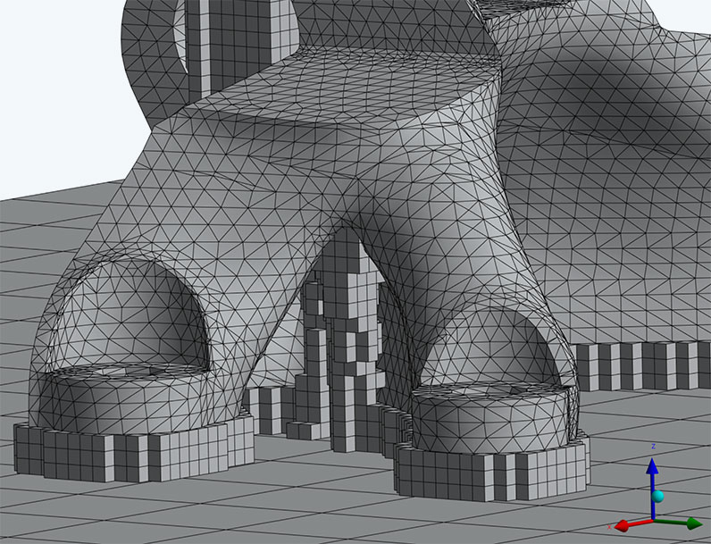 Detailed view of layered tetrahedron mesh for part and voxelized mesh for homogenized supports.